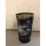A HORN BEAKER WITH A WHITE METAL RIM