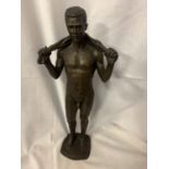 A RESIN FIGURINE OF A NAKED MAN