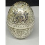 A WHITE METAL EGG SHAPED SHAKER