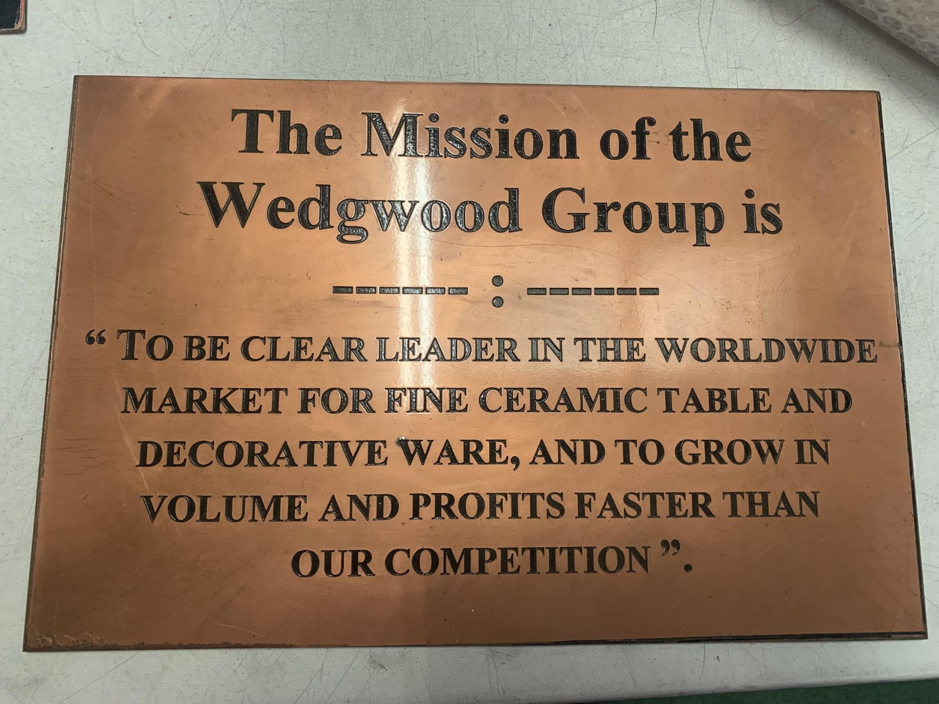 A COPPER SIGN 'THE MISSION OF THE WEDGWOOD GROUP' 37CM X 25CM