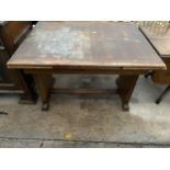 AN OAK DRAW-LEAF DINING TABLE