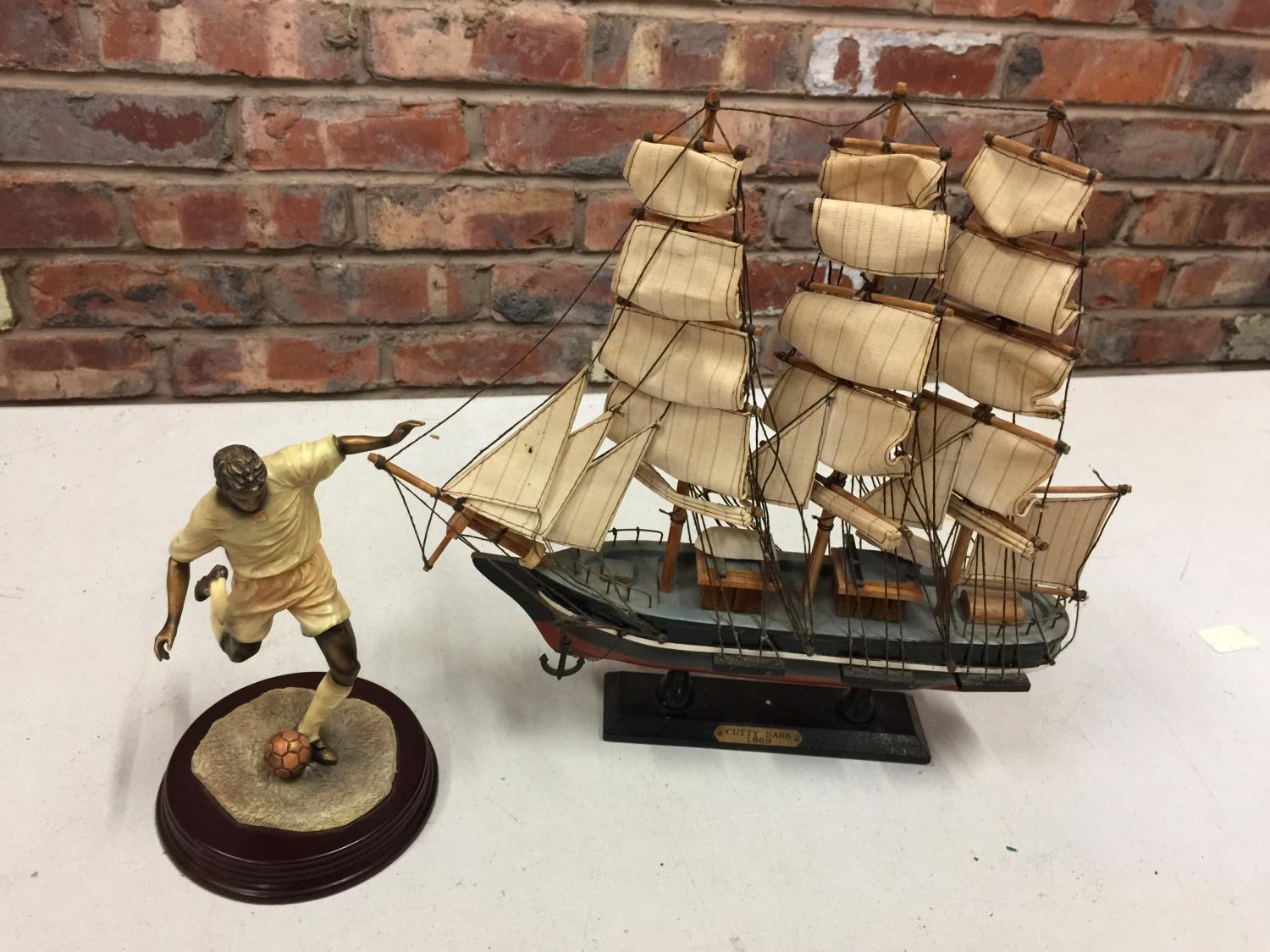 A HAND BUILT MODEL OF THE CUTTY SARK SAILING SHIP AND A FOOTBALLER FIGURINE