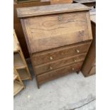 AN EARLY 20TH CENTURY OAK BUREAU 30 INCHES WIDE