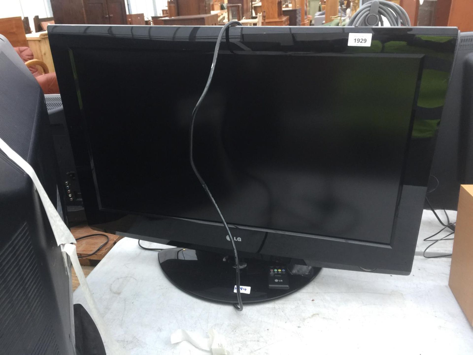 A 32" LG TELEVISION WITH REMOTE CONTROL
