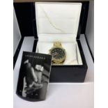 AN ASTON GERARD GOLD PLATED WATCH WITH DIAMONDS IN A PRESENTATION BOX