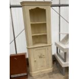 A MODERN PAINTED PINE CORNER CUPBOARD