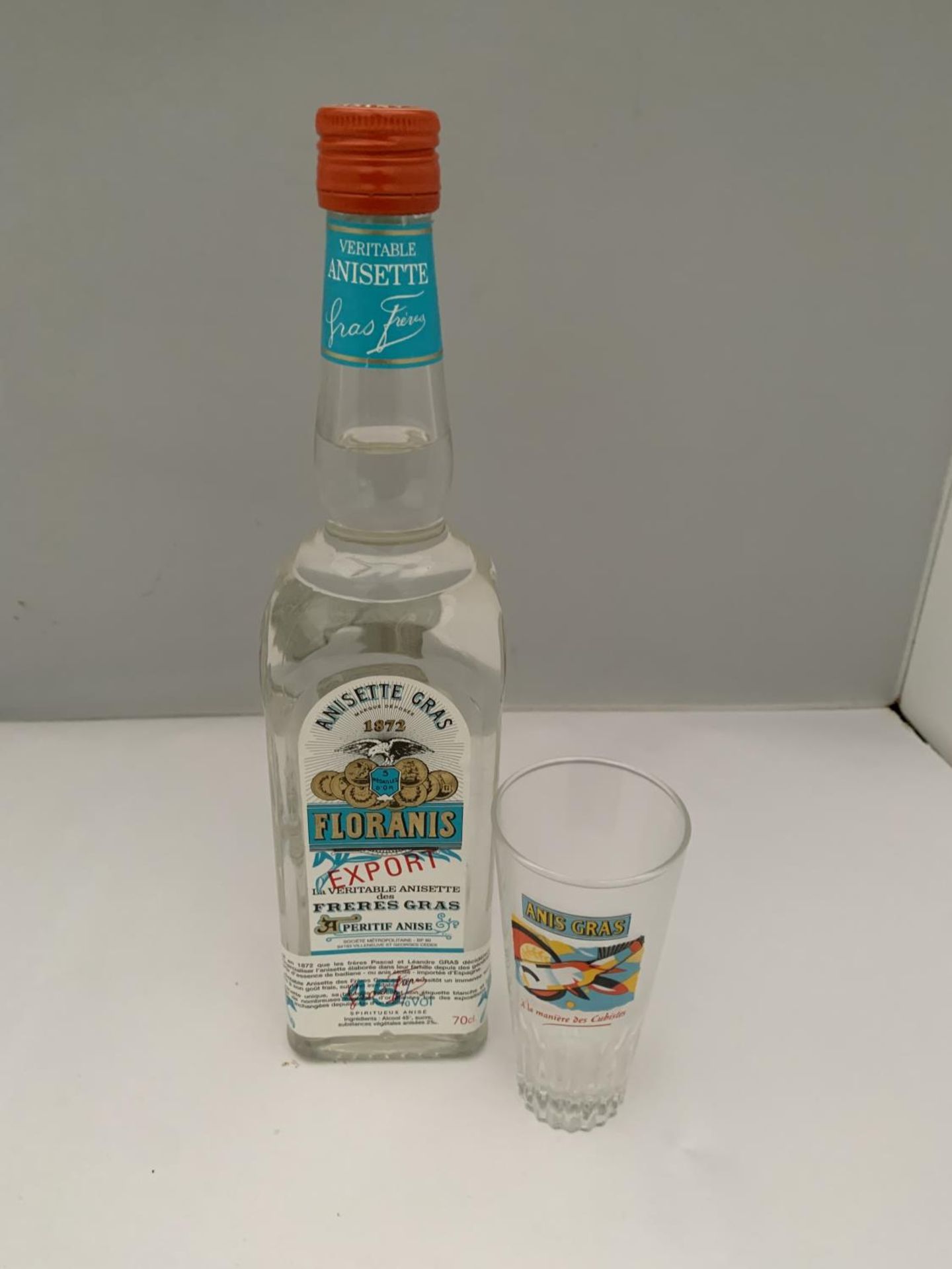 A LITRE BOTTLE OF ANISETTE GRAS 1872 FLORANIS EXPORT PERITIF ANISE 45% VOL WITH AN ANIS GRAS GLASS