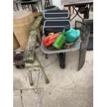 AN ASSORTMENT OF GARDEN ITEMS TO INCLUDE A WHEEL BARROW, TRESTLE BASES AND WATERING CANS ETC