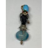 A BLACKAMORE PENDANT OF AN AFRICAN TRIBAL FIGURE WITH RUBYS, EMERALDS AND TURQUOISE STONES BY