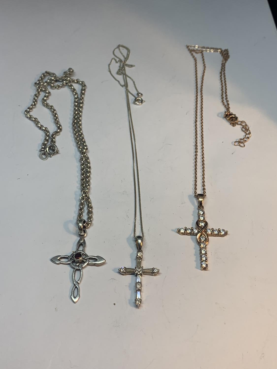 THREE MARKED SILVER NECKLACES WITH CROSS PENDANTS (ONE SILVER GILT)