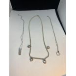 THREE MARKED SILVER NECKLACES ONE WITH FOUR HEART CHARMS AND TWO WITH PENDANTS TO INCLUDE A HEART