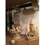 A RESIN MODEL OF A LADY ON A HORSE AND AN ORNATE TABLE LAMP DECORATED WITH CHERUBS AND HORSES