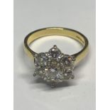 AN 18 CARAT GOLD RING WITH SEVEN MANUFACTURED DIAMONDS IN A FLOWER DESIGN SIZE M IN A PRESENTATION