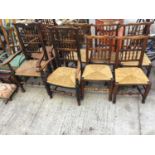 A HARLEQUIN SET OF EIGHT LANCASHIRE SPINDLE BACK RUSH SEATED CHAIRS COMPRISING OF FIVE SINGLES AND