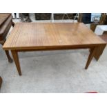 A 1970'S TEAK DRAW-LEAF DINING TABLE