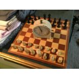 A WOODEN CHESS SET AND CHESS PIECES AND A CHESS TIMER CLOCK IN WORKING ORDER AT TIME OF LOTTING