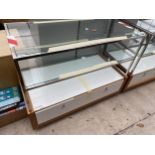 A WOODEN AND GLASS SHOP DISPLAY UNIT WITH LOWER DRAWER