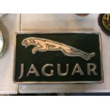 A CHROME AND RACING GREEN JAGUAR CAST SIGN