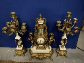 AN ORNATE IMPERIAL FRENCH GILT MANTLE CLOCK ON A MARBLE AND GILT BASE WITH CHERUB FAWN DECORATION