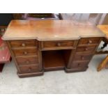 A VICTORIAN MAHOGANY BREAKFRONT DRESSING TABLE ENCLOSING SEVEN DRAWERS