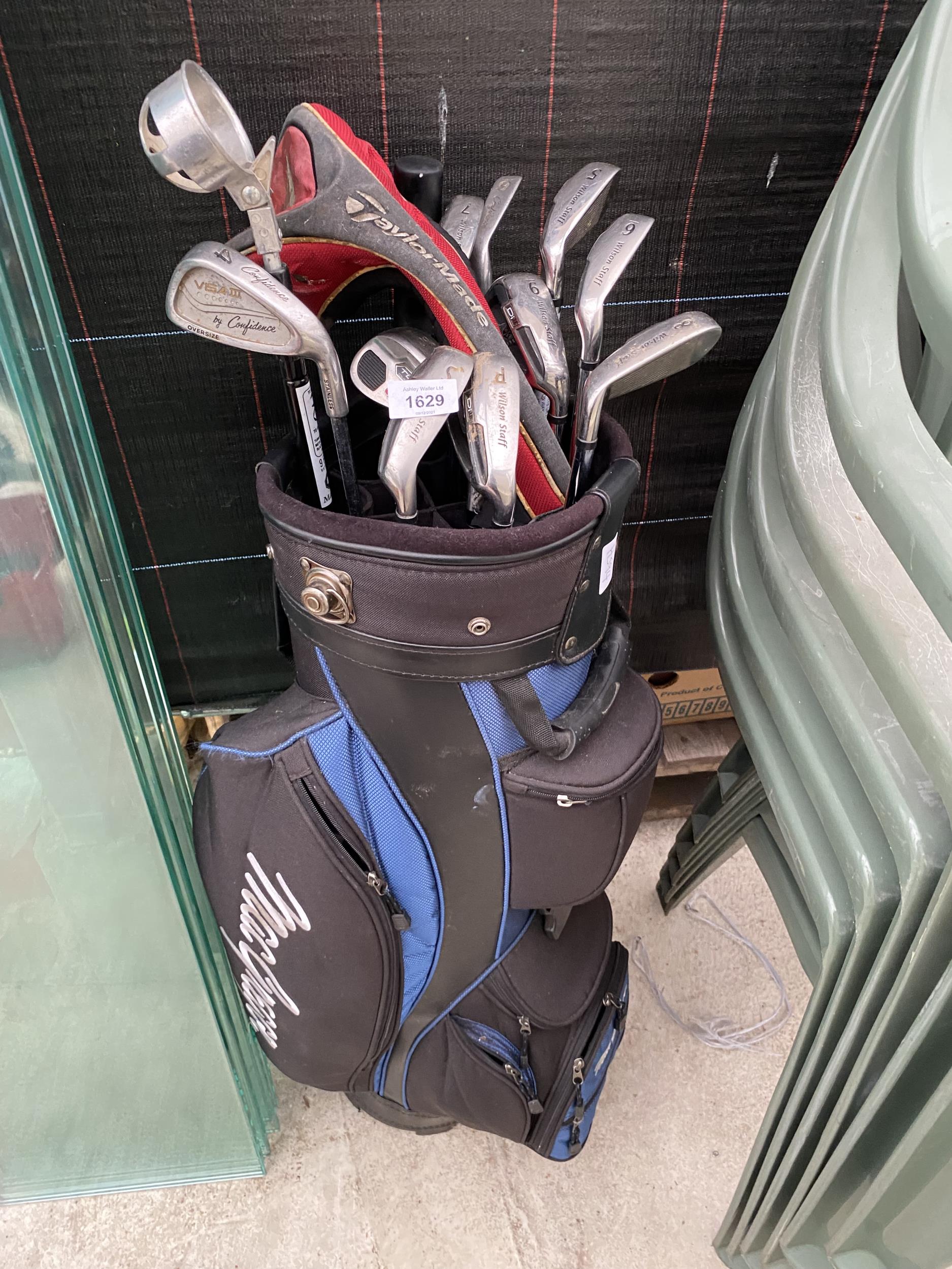 A GOLF BAG AND AN ASSORTMENT OF GOLF CLUBS