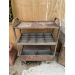 A VINTAGE FOUR WHEELED WORKSHOP TROLLEY WITH UPPER SHELF, LOCK BOX AND SECTIONAL SHELF