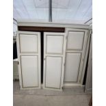 A PAINTED OAK THREE DOOR PANELLED WARDROBE, 70" WIDE