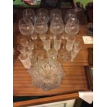 A COLLECTION OF GLASSWARE TO INCLUDE LARGE WINE GLASSES, CHAMPAGNE FLUTES, DISH ETC