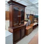 A VICTORIAN MAHOGANY TWO DOOR BOOKCASE ON BASE, 43" WIDE