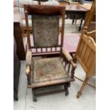 AN AMERICAN STYLE ROCKING CHAIR WITH TURNED SPINDLES