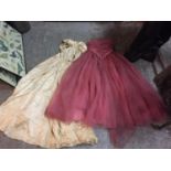 A DUSKY PINK STRAPLESS BALL GOWN AND A CREAM DRESS BOTH IN NEED OF REPAIR