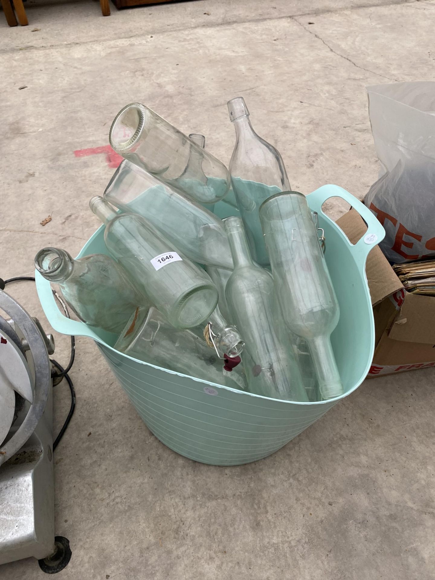 AN ASSORTMENT OF CLEAR GLASS WINE BOTTLES