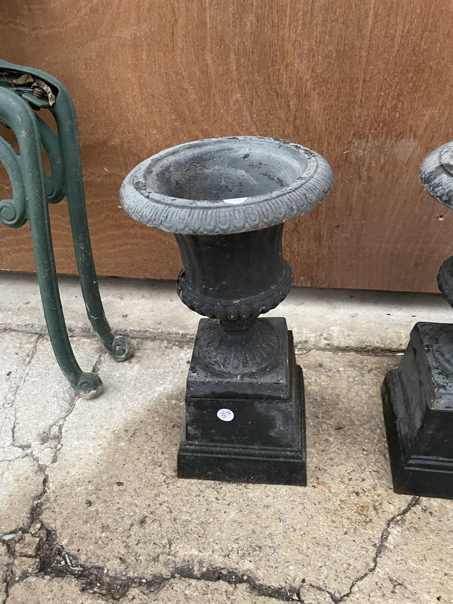 A PAIR OF SMALL DECORATIVE CAST IRON URN PLANTERS - Image 2 of 2