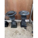 A PAIR OF DECORATIVE HEAVY CAST IRON URN PLANTERS