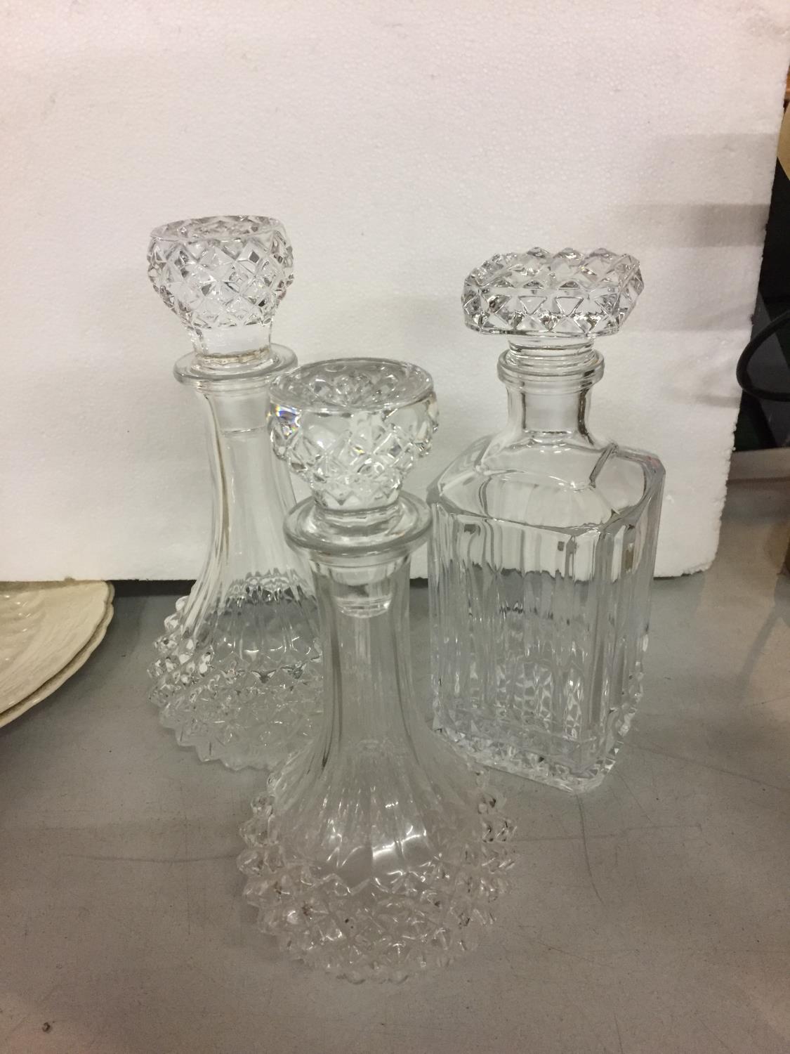 THREE GLASS DECANTERS