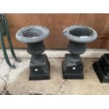 A PAIR OF SMALL DECORATIVE CAST IRON URN PLANTERS