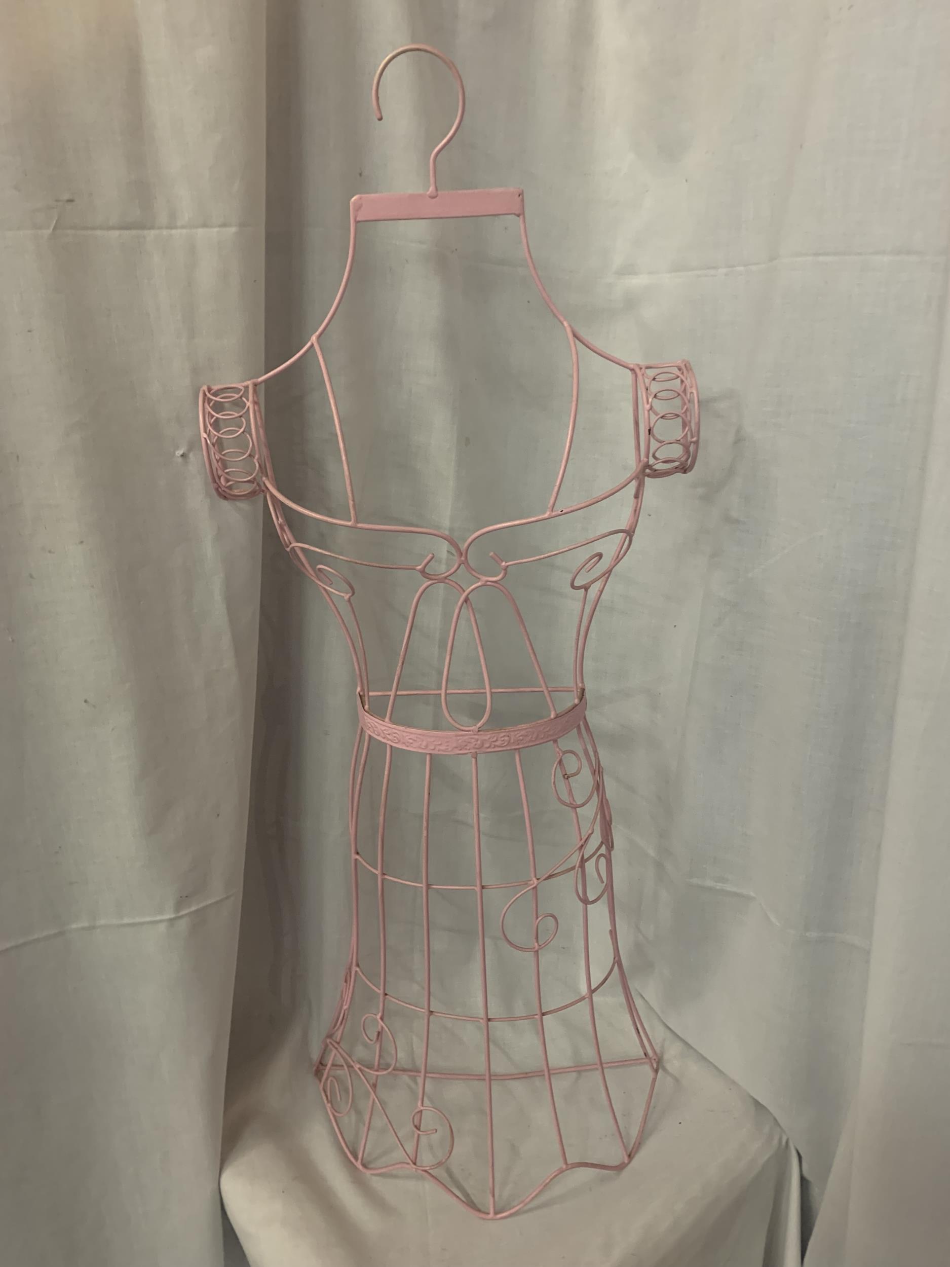 A PINK WIRE HANGING MANNEQUIN