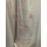 A PINK WIRE HANGING MANNEQUIN