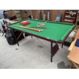 A FOLDING SNOOKER TABLE WITH THREE CUES, A TRINAGLE, SCORE BOARD AND A SET OF BALLS