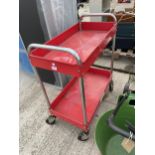 A RED TWO TIER TROLLEY