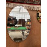 AN OVAL ART DECO BEVELED EDGE MIRROR