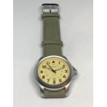 A SEKONDA WRIST WATCH WITH A GREEN CANVAS STRAP SEEN WORKING BUT NO WARRANTY