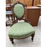 A VICTORIAN WALNUT NURSING CHAIR ON TURNED AND FLUTED FRONT LEGS