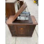 A JUNES ELECTRIC SEWING MACHINEIN EARLIER ART NOUVEAU CABINET