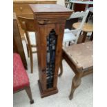 A HARDWOOD CD RACK WITH WROUGHT IRON INSET DOOR AND APPROX FORTY CD'S