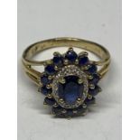 A 9 CARAT GOLD CLUSTER RING WITH A CENTRE SAPPHIRE AND SURROUNDING DIAMONDS AND SAPPHIRES SIZE 0