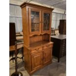 A REPRODUCTION TWO DOOR GLAZED AND LEADED DRESSER WITH CUPBOARDS AND DRAWERS TO THE BASE, 40" WIDE