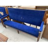 A LARGE OAK FRAMED SETTLE WITH UPHOLSTERED SEAT AND BACK, 84" WIDE, BEARING A.M.TOMLINSON, JOINER