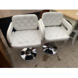 A PAIR OF WHITE BUTTON-BACK ADJUSTABLE STOOL ARMCHAIRS ON CHROME BASES