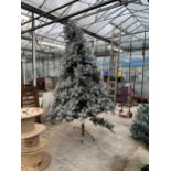 AN ARTIFICIAL SNOW CHRISTMAS TREE ALL COMPLETE WITH STAND APPROXIMATELY 8FT TALL